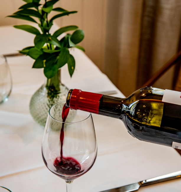 Restaurantes del Hotel Los Molinillos Copa de vino tinto servida en una mesa del restaurante